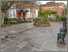 [thumbnail of Paving laid in rose garden, with circle areas left for handmade tiles to be installed]