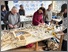 [thumbnail of Community tile making workshop, using the hand made tools and stamps to create patterns in the white clay body, to then fill with blue clay slip]